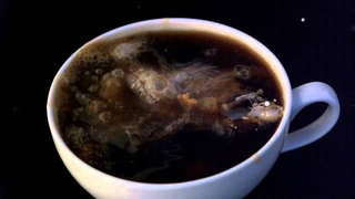 Pouring creamer into coffee in slow motion looks intergalactic